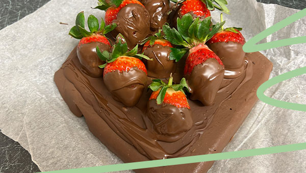 place chocolate dipped strawberries onto fudge