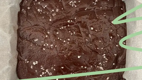 sprinkle sea salt flakes onto dark chocolate sea salt fudge