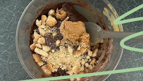 mix in peanut butter and biscuits into chocolate fudge