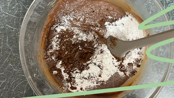 Sift in confectioner sugars and cocoa powder in ferrero rocher fudge
